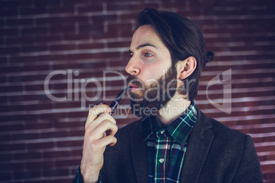 Fashionable man smoking pipe