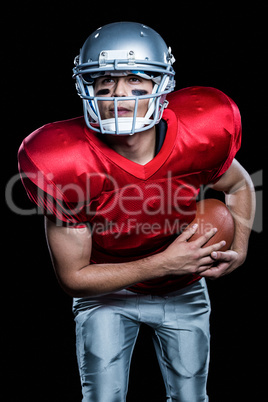 American football player holding ball