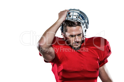 American football player in removing helmet