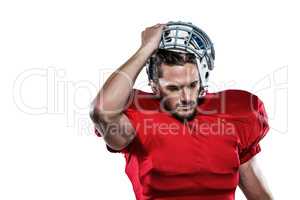 American football player in removing helmet