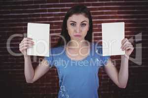 Pretty brunette holding two pages