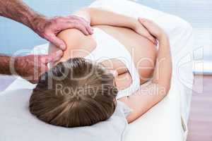 Close-up of male masseur massaging pregnant woman