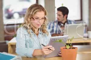 Young woman using digital tablet at creative office