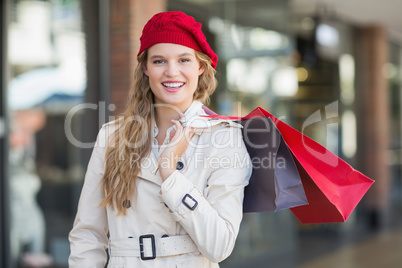 A smiling woman with shopping bags