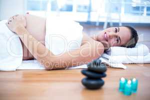 Pregnant woman touching belly in spa