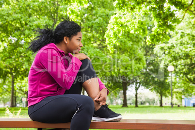 Fit woman sitting on bench