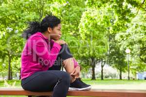 Fit woman sitting on bench