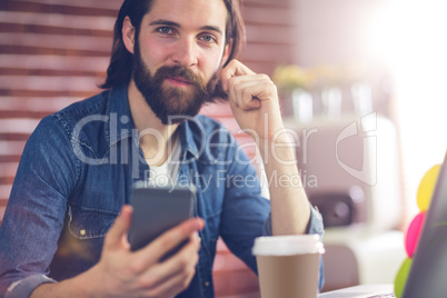 Portrait of smart businessman using cellphone