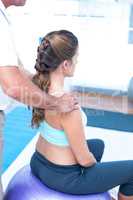 Pregnant woman having relaxing massage at gym