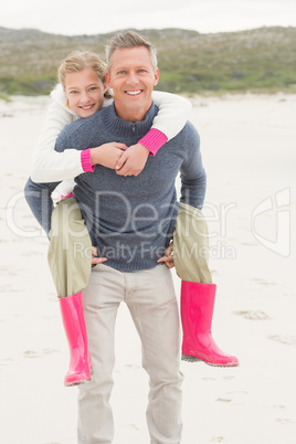 Father giving his daughter a piggy back