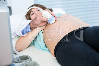 Midsection of male doctor doing ultrasound test