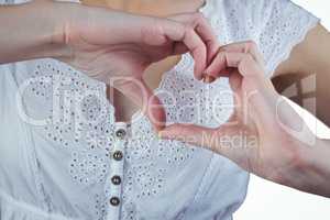 Woman making heart shape with hands