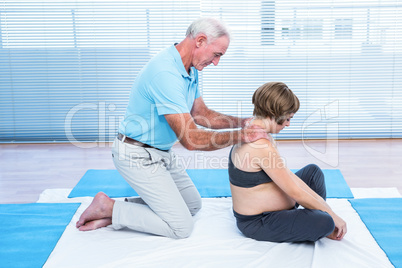 Therapist massaging pregnant woman