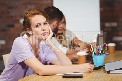 Portrait of businesswoman with hand on chin