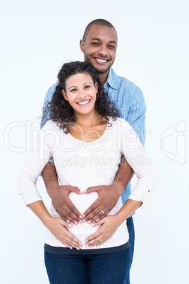 Portrait of couple with hands on belly