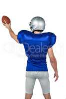 Rear view of sports player holding ball