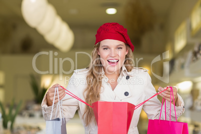 A happy smiling woman looking into a bag