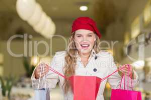 A happy smiling woman looking into a bag