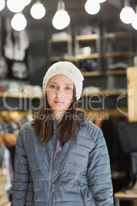 Serious pretty brunette looking at camera with winter clothes