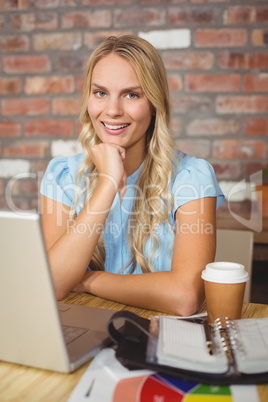 Portrait of smiling beautiful woman with hand on chin