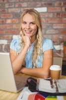 Portrait of smiling beautiful woman with hand on chin