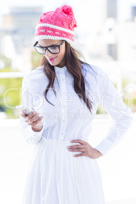 Pretty brunette using her smartphone