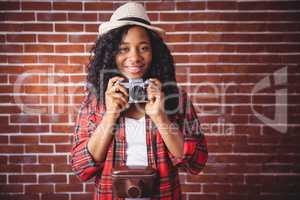 Hipster smiling and holding camera