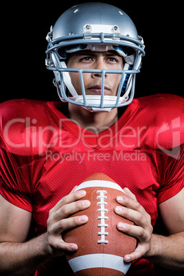 Determined sportsman holding American football