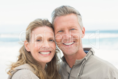 Smiling couple holding one another