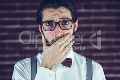 Portrait of nervous man covering mouth