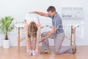 Doctor stretching a woman back