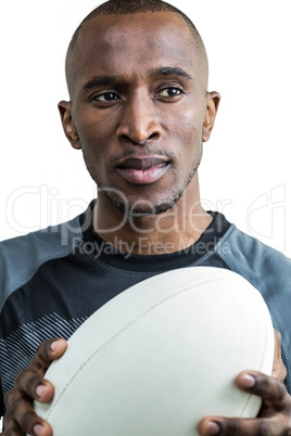 Close-up of athlete thinking while holding rugby ball