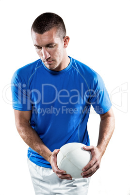 Rugby player holding ball aside