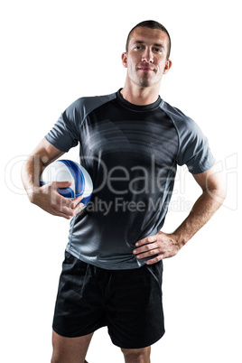 Rugby player holding ball with hand on hip