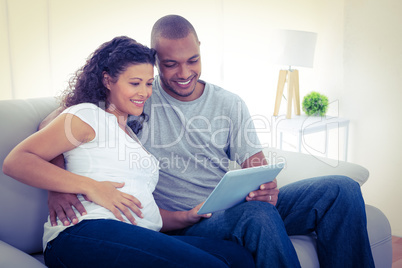 Couple using tablet computer