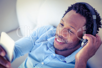 High angle view of cheerful man using smartphone