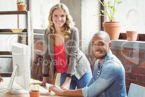 Smiling man and woman in  office