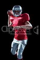 Portrait of sportsman throwing American football