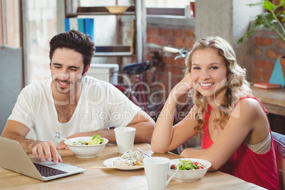 Portrait of smiling business sitting by colleague