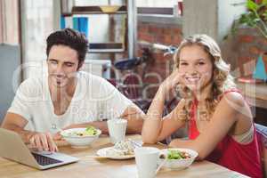 Portrait of smiling business sitting by colleague