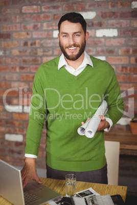 Portrait of businessman holding folded papers