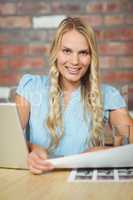 Portrait of smiling woman holding photos