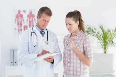 Doctor showing clipboard to his patient