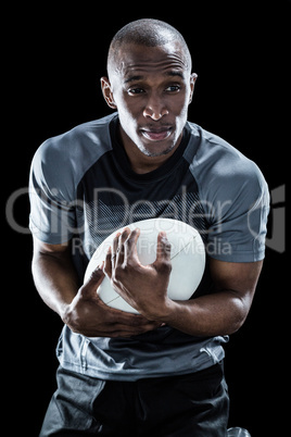 Rugby player smiling while catching ball