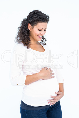 Happy pregnant woman touching abdomen
