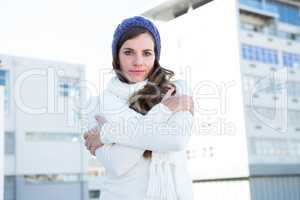 Brunette with warm clothes looking at camera