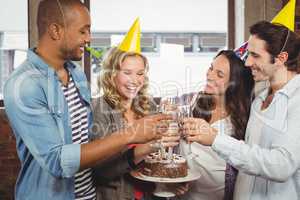 Colleagues laughing while toasting with champagne