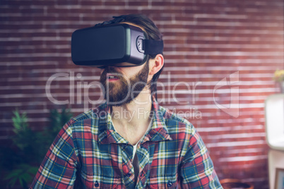 Creative businessman wearing 3D video glasses while looking away