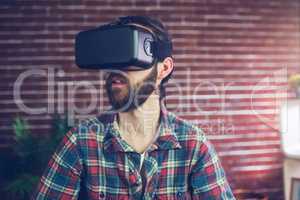 Creative businessman wearing 3D video glasses while looking away