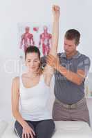 Doctor stretching a young woman arm